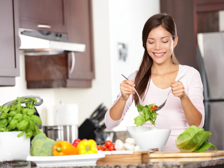 Woman with food that she's making from her monthly meal plan.